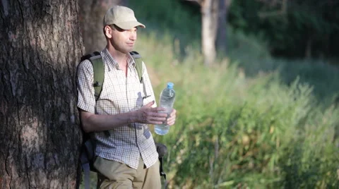 Man drinking water in the forest Stock Footage 1097896