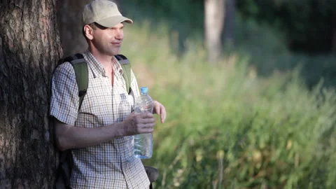 Man drinking water in the forest Stock Footage 85922342