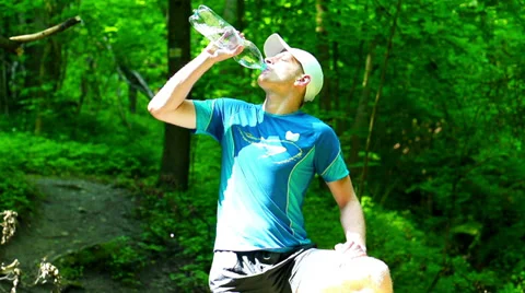 Man drinking water in forest, steadycam shot, slow motion shot at 240fps Видео 39788093