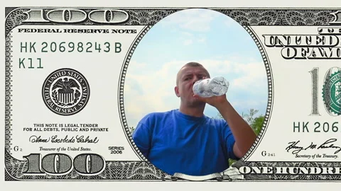 Man is drinking water in frame of 100 dollar bill Stock Footage 96724720