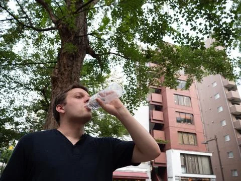 A man drinking water from a plastic bottle Foto stock