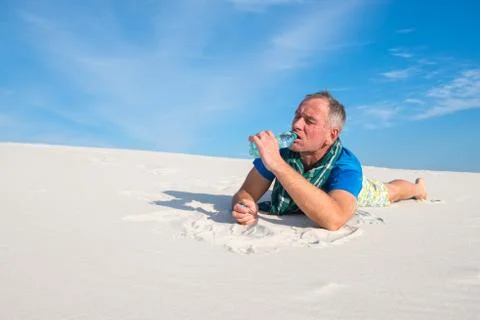 Man drinking water from a small plastic bottle Stock Photos