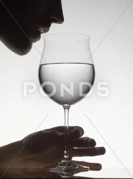 Man Drinking Water From Wine Glass
