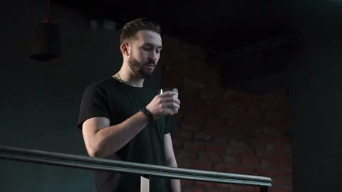 Man is drinking whiskey at the parapet Video stock 86250825