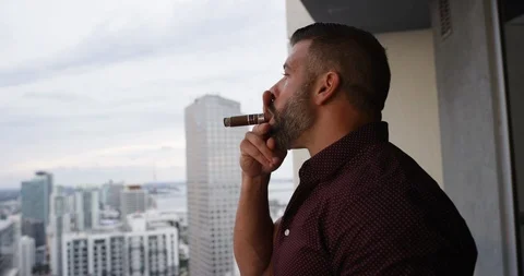 Man drinking whisky while smoking cigar Stock Footage 116349597