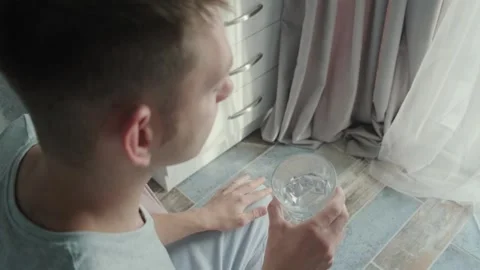 Man drinking white capsule with collagen with glass of water. Nutritional Video stock 262364595