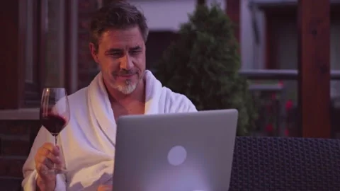 Man drinking wine and working on laptop outdoor Stock Footage 162681406