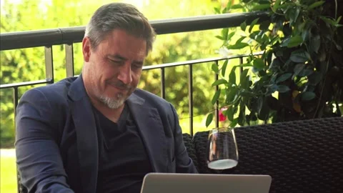 Man drinking wine and working on laptop outdoor Video stock 162682084