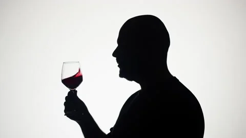 Man drinking wine on white background. Shadow silhouette of male person Stock Footage 181991050