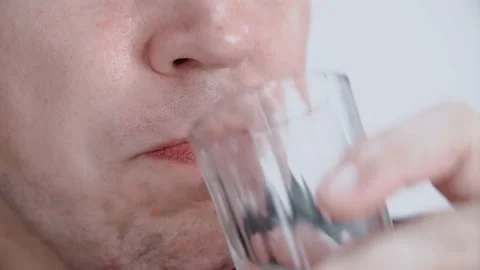 The man drinks alcohol and sniffs bread. Close-up. Stock Footage 147926484