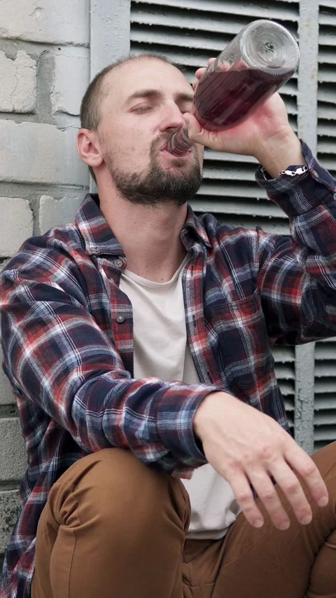 A man drinks alcohol, immersed in depression and emotional pain. Stock Footage 330057532
