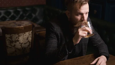 Man drinks alone at table,loneliness and depression, concept of alcoholic Stock Footage 129801882