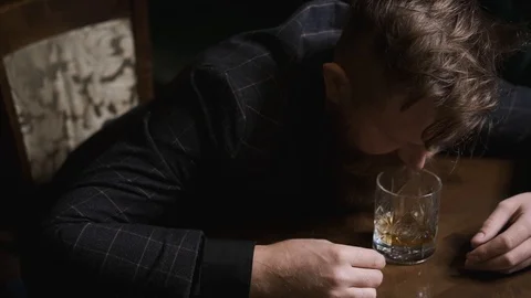 Man drinks alone at table,loneliness and depression, concept of alcoholic Stock Footage 129801935