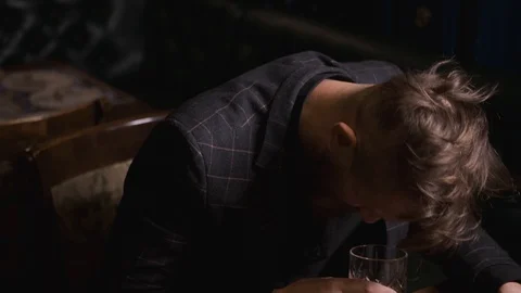 Man drinks alone at table,loneliness and depression, concept of alcoholic Stock Footage 129801978