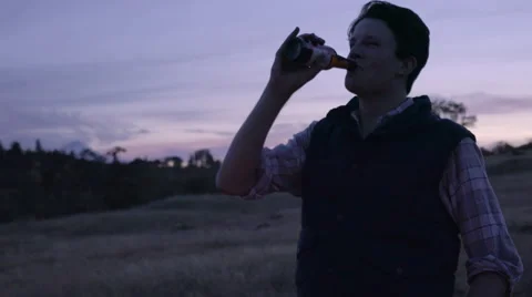 Man Drinks A Beer And Talks To Friends Off-Screen Stock Footage 68107812