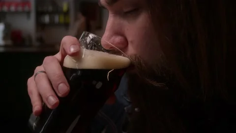 A man drinks beer in a cafe Stock Footage 223880854