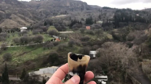 A man drinks chacha (vodka) from a ram's horn. Georgia. March 2019 Video stock 112520422