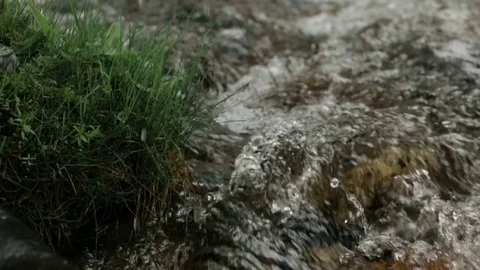 A man drinks clean water from a mountain stream with his hands Stock Footage 73349382