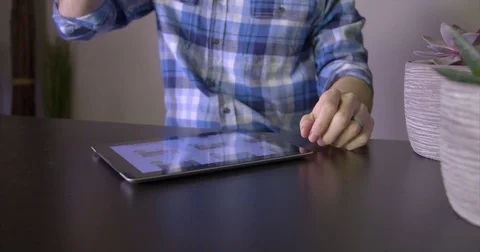 Man drinks coffee and uses tablet Stock Footage 85413533