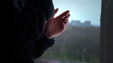 Man Drinks Coffee from Cup in Black Bathrobe at an Open Window in the Morning Stock Footage 178613906