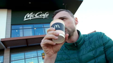Man drinks coffee from a cup with McDonald's logo, Minsk, Belarus, April 8, 2020 Stock Footage 134463364