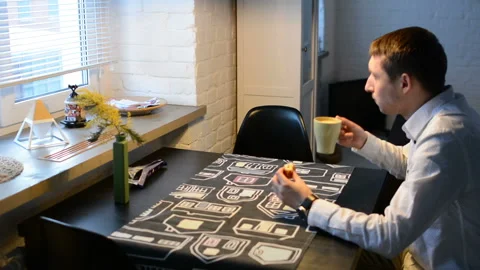 A man drinks coffee in the kitchen 動画素材 87429720