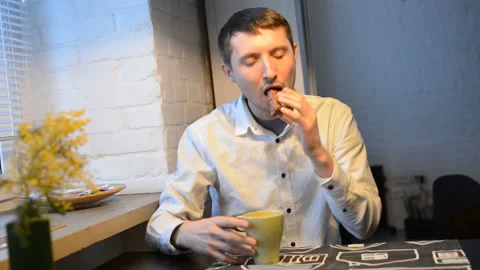 A man drinks coffee in the kitchen Stock Footage 87433053