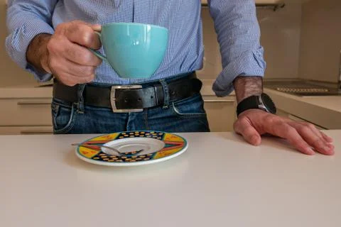Man drinks a coffee  on the kitchen table Stock Photos