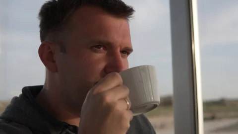 A man drinks coffee slowly. Close-up, slow motion. Stock Footage 107880174