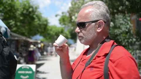 A man drinks coffee on the streets of the old Italian town Stock Footage 51886401
