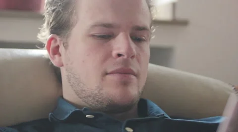 Man drinks coffee while reading Stock Footage 40660344