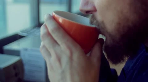 Man drinks coffee while working in the startup office Stock Footage 62948128
