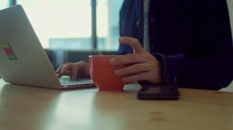 Man drinks coffee while working in the startup office Stock Footage 62948158