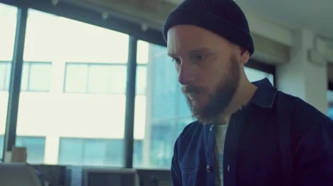Man drinks coffee while working in the startup office Stock Footage 62948196