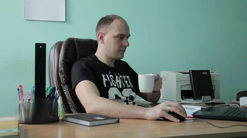 Man drinks coffee while working in the startup office Stock Footage 71962809