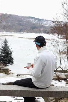Man drinks coffee in winter time in fresh air Stock Photos