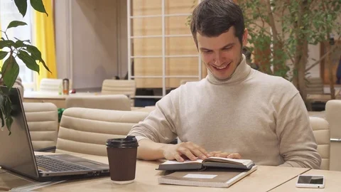 Man drinks coffee at the working hub Stock Footage 76326962