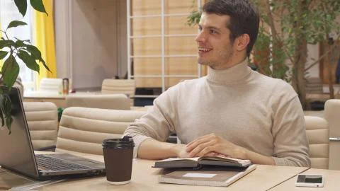 Man drinks coffee at the working hub Stock Photos