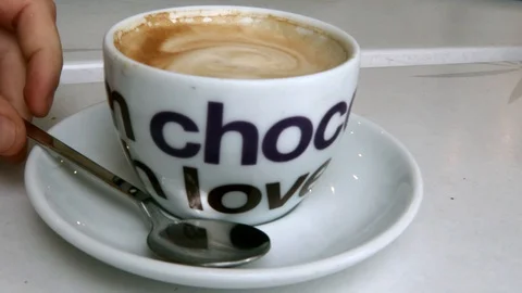 Man drinks cup of cappuccino Video stock 129559992