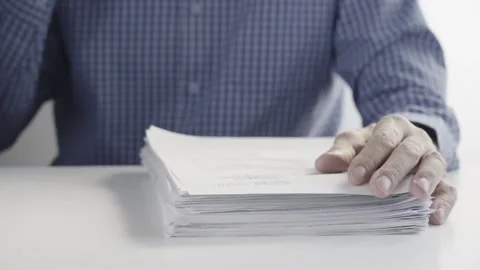 Man Drinks a Cup of Coffee and Works with a Stack of Documents at the Office 스톡 동영상 150016446