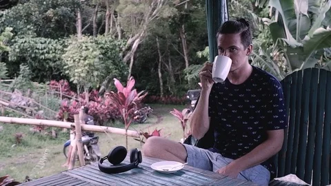 A man drinks a cup of coffee. Video stock 122498794