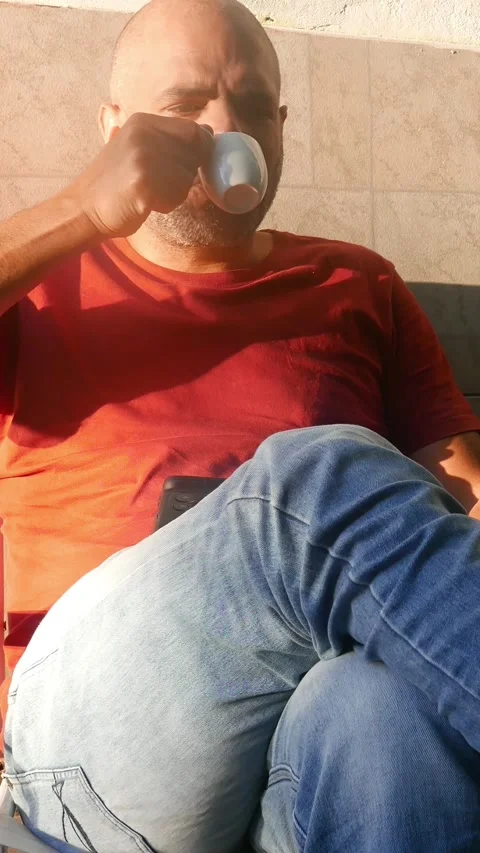 A man drinks a cup of coffee. Instant coffee. A coffee cup. A coffee mug. Stock Footage 318990929