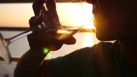 A man drinks a delicious cool wine at sunset, with a lens effect. HD, 1920x1080 Stock Footage 80517622