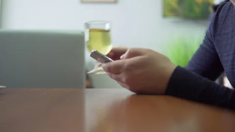 A man drinks a drink and uses a mobile phone Stock Footage 87110459