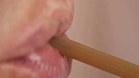 A man drinks a drink through a plastic cocktail tube, close-up Stock Footage 143971198