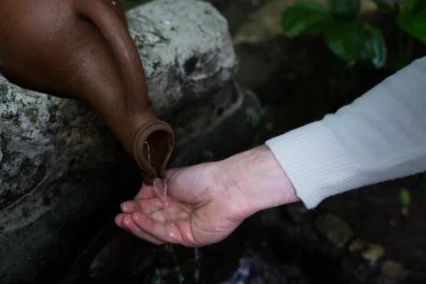A man drinks from a drinkable mountain spring Stock Photos