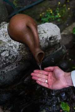 Man drinks from a drinkable mountain spring Stock Photos