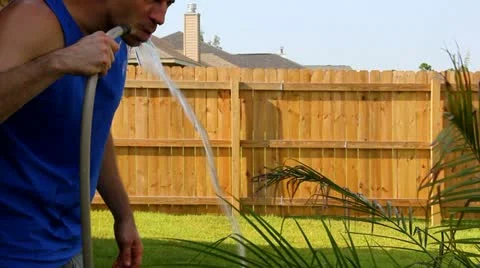 Man Drinks from Hose Stock Footage 11695197