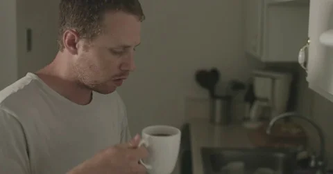 Man drinks hot cup of tea Video stock 78038352