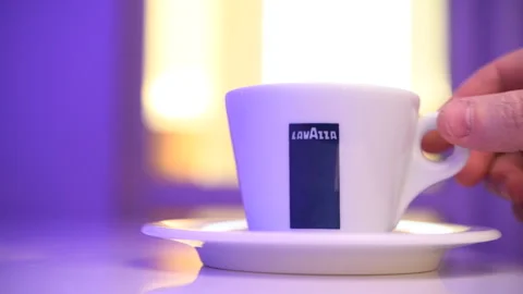 A man drinks Lavazza coffee in a cafe. Stock Footage 302827641